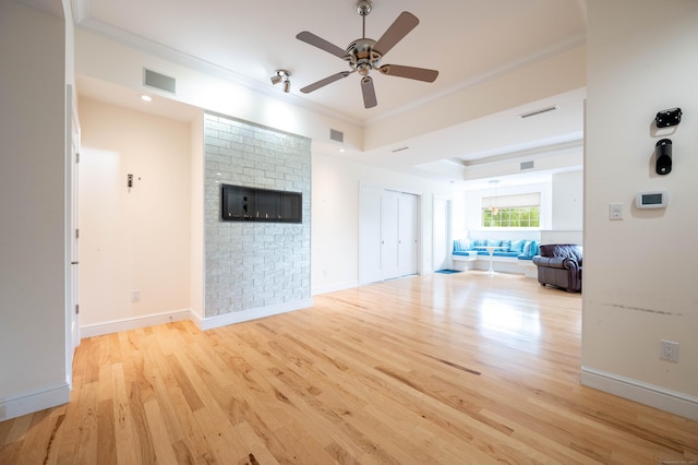 557 Upper Grassy Hill Rd, Woodbury, CT 06798 - unfurnished living room featuring ornamental molding, wood finished floors, a ceiling fan, and a raised ceiling