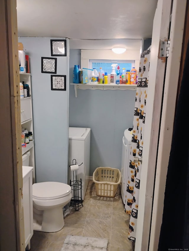 268 Flanders Rd Trlr 20, Groton, CT 06355 - bathroom featuring toilet and washing machine and clothes dryer