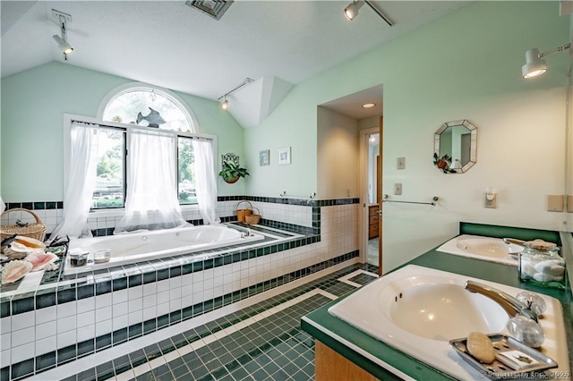 166 Old Colchester Rd, Salem, CT 06420 - full bathroom with rail lighting, lofted ceiling, double vanity, a bath, and tile patterned flooring