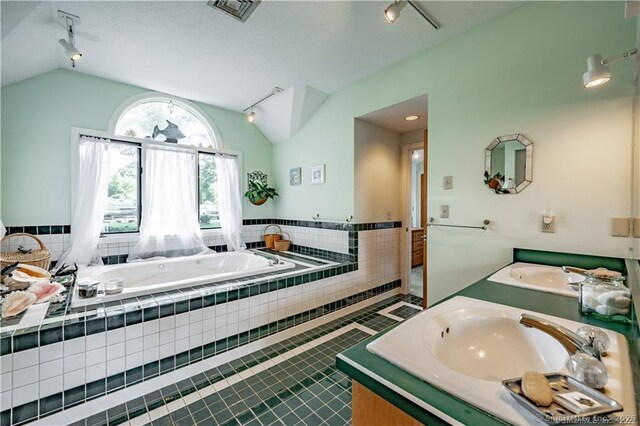 166 Old Colchester Rd, Salem, CT 06420 - bathroom with track lighting, lofted ceiling, double vanity, a bath, and tile patterned floors