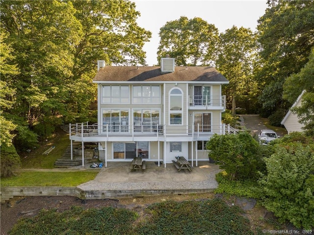166 Old Colchester Rd, Salem, CT 06420 - rear view of property featuring a patio area, a balcony, and a chimney
