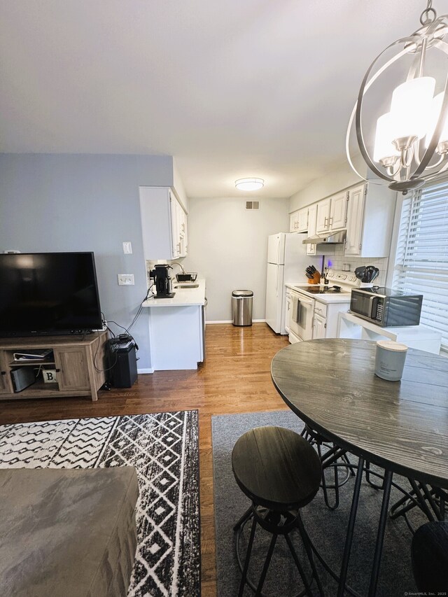 21 Prospect Ave Unit A101, Norwalk, CT 06850 - living area with a chandelier and light wood finished floors