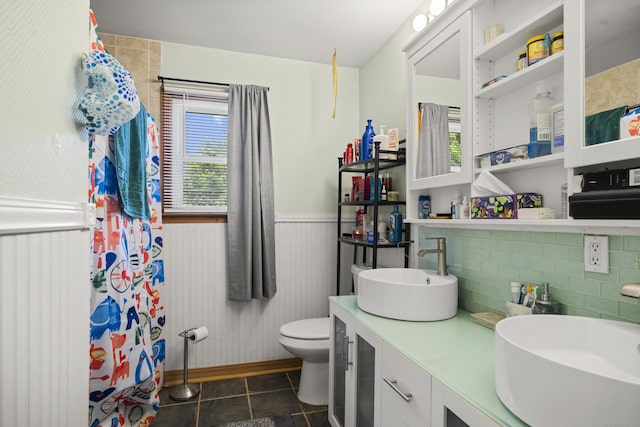 8 Cornfield Rd, Waterbury, CT 06704 - bathroom with plenty of natural light, a wainscoted wall, tile patterned flooring, double vanity, and backsplash