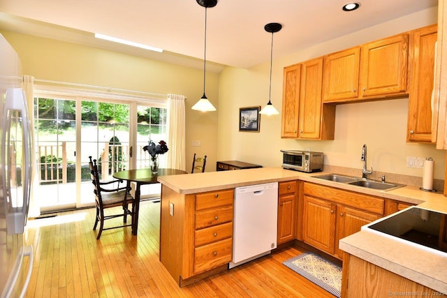 375 Allyn St Unit A4, Groton, CT 06355 - kitchen featuring dishwasher, a peninsula, freestanding refrigerator, light countertops, and recessed lighting