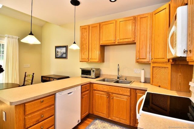 375 Allyn St Unit A4, Groton, CT 06355 - kitchen with white appliances, a peninsula, light countertops, and hanging light fixtures