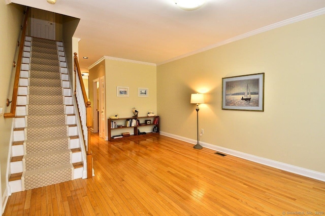 375 Allyn St Unit A4, Groton, CT 06355 - spare room with light wood finished floors, ornamental molding, and stairway