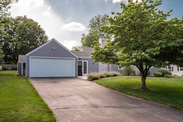 21 Walnut St, Newington, CT 06111 - view of front of house with a front yard, driveway, a garage, and a chimney