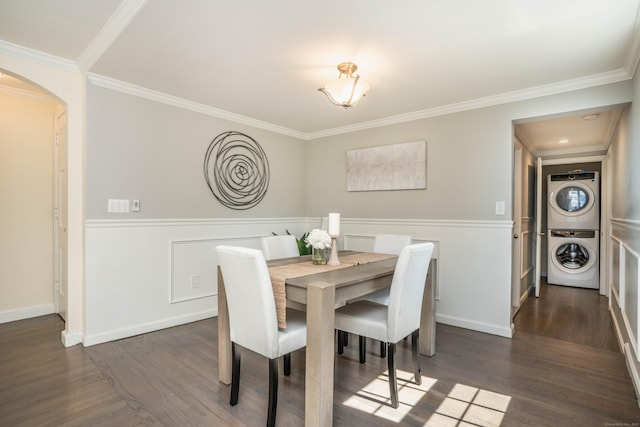21 Walnut St, Newington, CT 06111 - dining area with stacked washer and clothes dryer, arched walkways, ornamental molding, a wainscoted wall, and dark wood finished floors