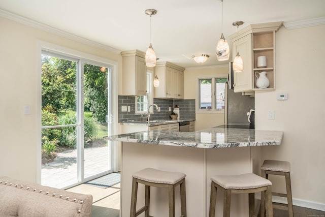 21 Walnut St, Newington, CT 06111 - kitchen with cream cabinets, open shelves, ornamental molding, backsplash, and a peninsula