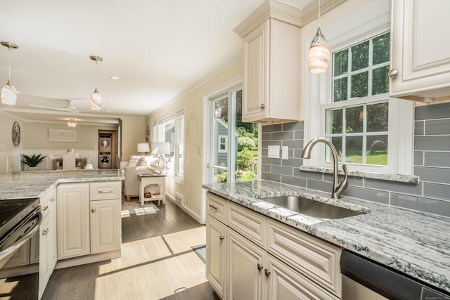21 Walnut St, Newington, CT 06111 - kitchen with appliances with stainless steel finishes, cream cabinetry, tasteful backsplash, light wood-type flooring, and light stone countertops
