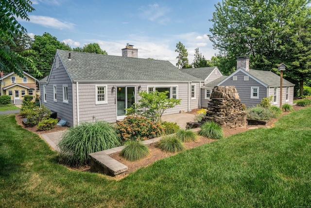 21 Walnut St, Newington, CT 06111 - rear view of house featuring roof with shingles, a lawn, a chimney, and a patio