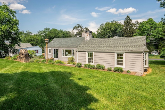 21 Walnut St, Newington, CT 06111 - view of front of house with a shingled roof, a front lawn, and a chimney