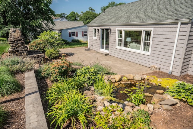 21 Walnut St, Newington, CT 06111 - back of house featuring roof with shingles and a patio area
