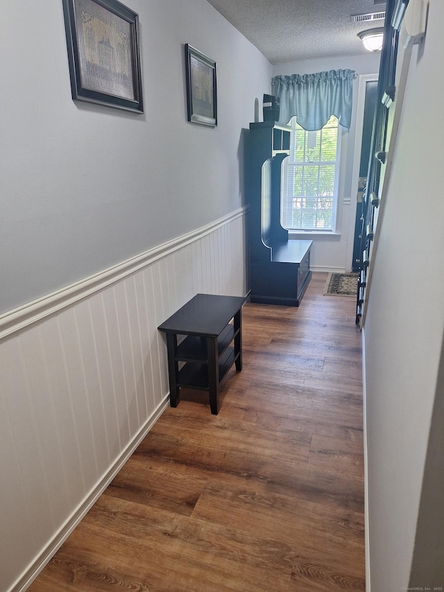67 Fox Hollow Dr Unit 67, Windsor Locks, CT 06096 - hall featuring wood finished floors, wainscoting, and a textured ceiling