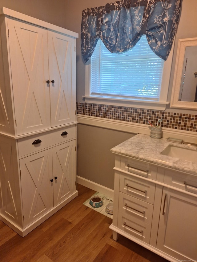 67 Fox Hollow Dr Unit 67, Windsor Locks, CT 06096 - bathroom with vanity, wood finished floors, and backsplash