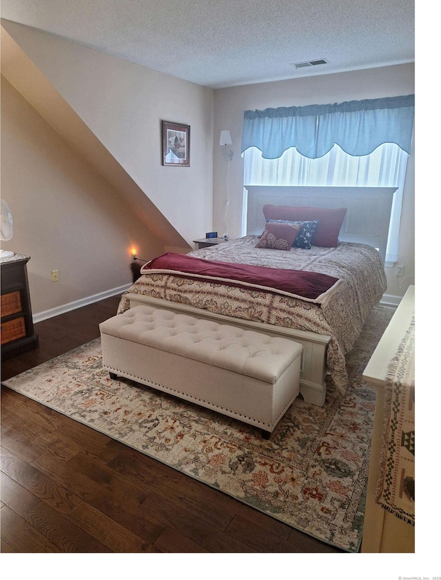 67 Fox Hollow Dr Unit 67, Windsor Locks, CT 06096 - bedroom with wood finished floors, multiple windows, and a textured ceiling
