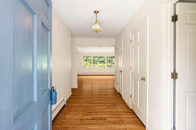 173 Russet Rd, Stamford, CT 06903 - hallway featuring a baseboard radiator, baseboard heating, light wood-type flooring, and a chandelier