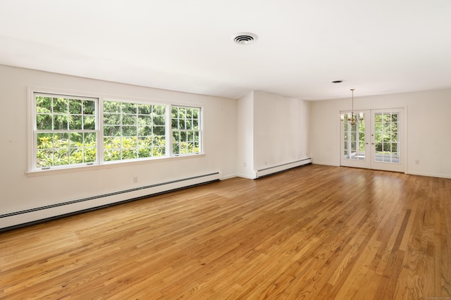 173 Russet Rd, Stamford, CT 06903 - empty room featuring a baseboard radiator, light wood-style flooring, and healthy amount of natural light