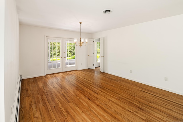 173 Russet Rd, Stamford, CT 06903 - unfurnished room with a baseboard radiator, a chandelier, wood finished floors, and french doors