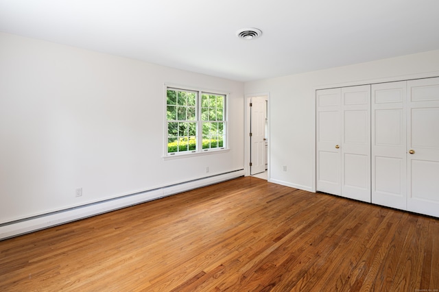 173 Russet Rd, Stamford, CT 06903 - unfurnished bedroom featuring a baseboard radiator, wood finished floors, and a closet