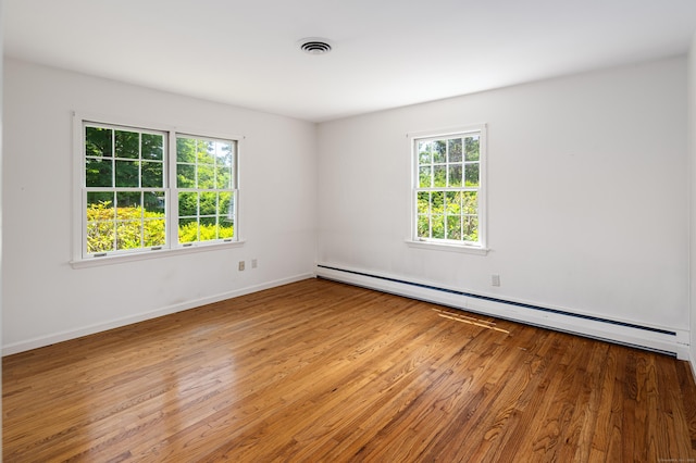 173 Russet Rd, Stamford, CT 06903 - spare room with a baseboard heating unit, plenty of natural light, and wood finished floors