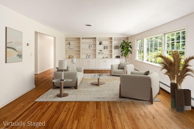 173 Russet Rd, Stamford, CT 06903 - living room with a baseboard radiator, light wood-style flooring, and built in features