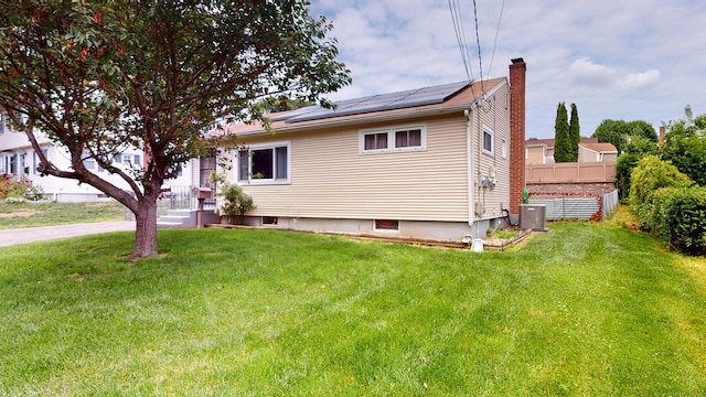 35 Cianci Rd, New Britain, CT 06053 - view of home's exterior featuring roof mounted solar panels and a chimney