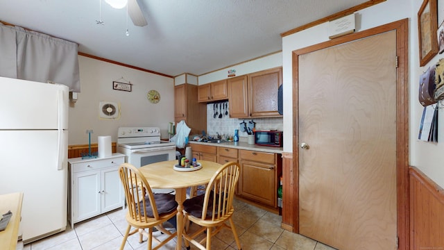 35 Cianci Rd, New Britain, CT 06053 - kitchen featuring white appliances, light tile patterned floors, ceiling fan, crown molding, and light countertops