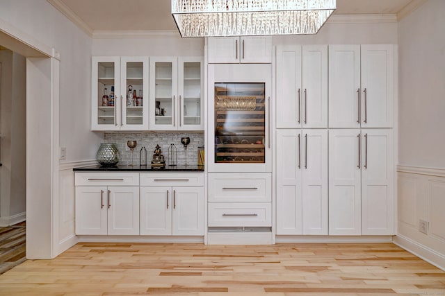 2 Abbey Ln, Newtown, CT 06470 - indoor bar featuring light wood-style flooring, ornamental molding, tasteful backsplash, beverage cooler, and wainscoting