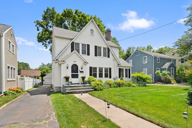 140 Griswold Dr, West Hartford, CT 06119 - view of front facade with a chimney, an outdoor structure, a garage, and roof with shingles