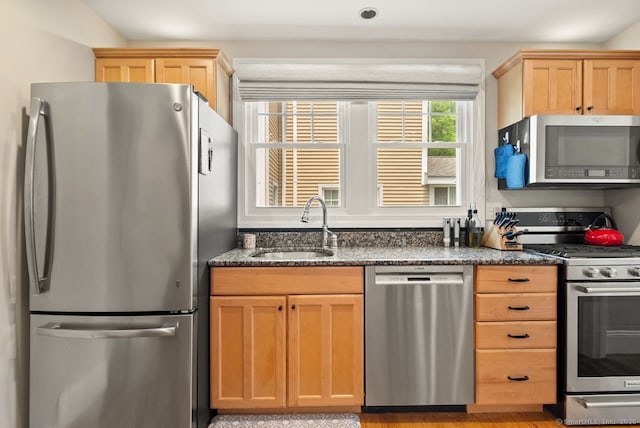140 Griswold Dr, West Hartford, CT 06119 - kitchen with appliances with stainless steel finishes, dark stone counters, and light brown cabinets
