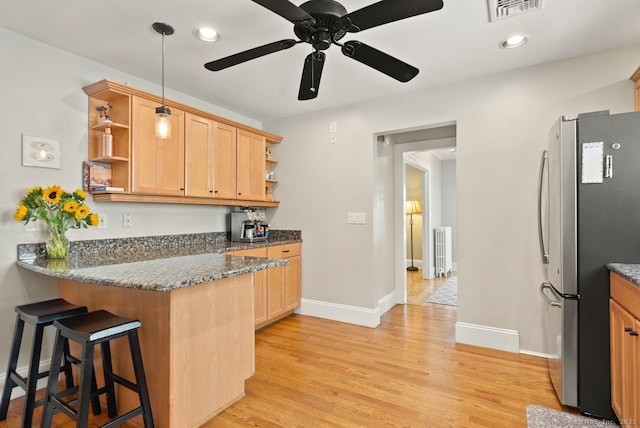 140 Griswold Dr, West Hartford, CT 06119 - kitchen featuring freestanding refrigerator, open shelves, radiator heating unit, a breakfast bar, and recessed lighting