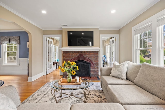 140 Griswold Dr, West Hartford, CT 06119 - living room with wood finished floors, healthy amount of natural light, ornamental molding, a brick fireplace, and recessed lighting