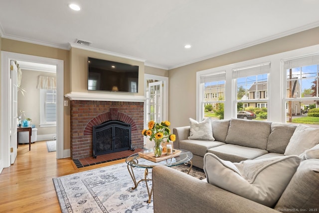 140 Griswold Dr, West Hartford, CT 06119 - living room with ornamental molding, light wood finished floors, recessed lighting, and a brick fireplace