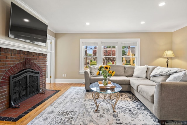 140 Griswold Dr, West Hartford, CT 06119 - living room with wood finished floors, ornamental molding, a brick fireplace, and recessed lighting