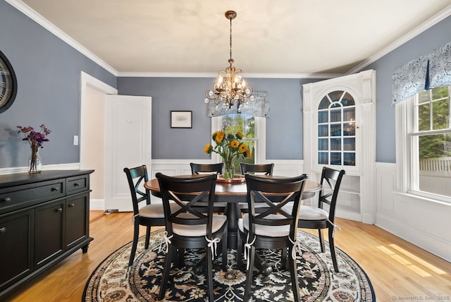 140 Griswold Dr, West Hartford, CT 06119 - dining room with a chandelier, light wood-style floors, wainscoting, and ornamental molding