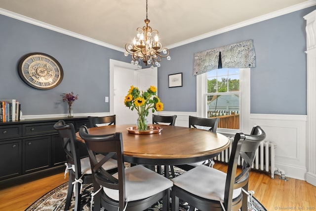 140 Griswold Dr, West Hartford, CT 06119 - dining room featuring radiator, crown molding, wainscoting, light wood-type flooring, and a chandelier