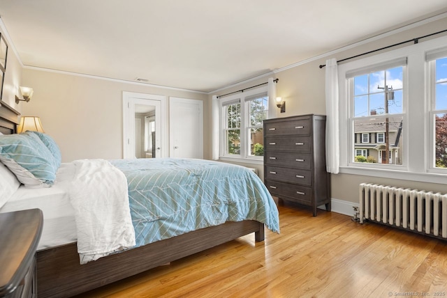 140 Griswold Dr, West Hartford, CT 06119 - bedroom with radiator heating unit, light wood finished floors, and ornamental molding