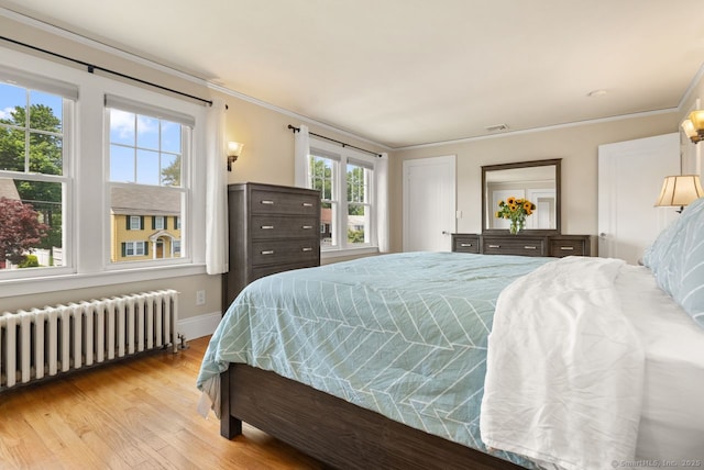 140 Griswold Dr, West Hartford, CT 06119 - bedroom with radiator heating unit, light wood-style floors, and crown molding