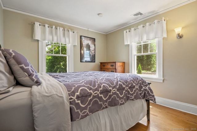 140 Griswold Dr, West Hartford, CT 06119 - bedroom featuring ornamental molding, multiple windows, and wood finished floors