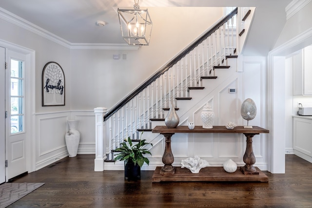 13 Myrtle St, Norwalk, CT 06855 - entrance foyer featuring a decorative wall, stairway, dark wood-style flooring, a chandelier, and crown molding