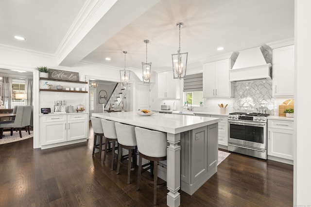 13 Myrtle St, Norwalk, CT 06855 - kitchen featuring stainless steel range with gas cooktop, premium range hood, light countertops, tasteful backsplash, and white cabinets