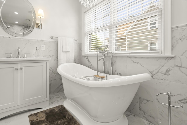 13 Myrtle St, Norwalk, CT 06855 - full bathroom featuring marble tiled flooring, tile walls, vanity, a soaking tub, and wainscoting
