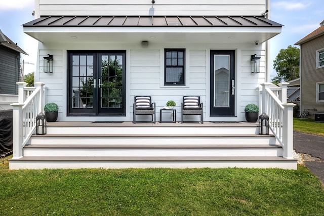 13 Myrtle St, Norwalk, CT 06855 - view of exterior entry featuring a standing seam roof, a metal roof, and a security system