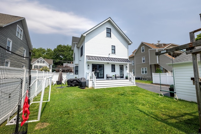 13 Myrtle St, Norwalk, CT 06855 - rear view of house featuring a fenced backyard, a standing seam roof, and a metal roof