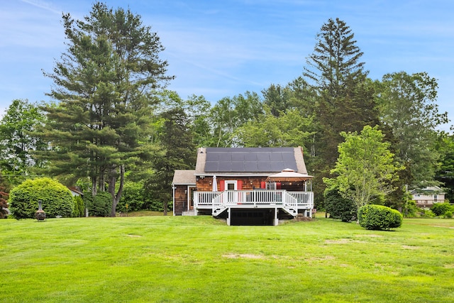 57 Falls Bashan Rd, East Haddam, CT 06469 - back of property featuring solar panels, a yard, and a wooden deck