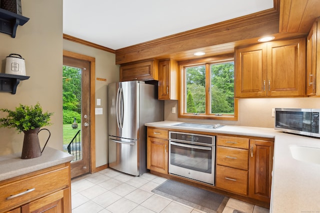 57 Falls Bashan Rd, East Haddam, CT 06469 - kitchen featuring stainless steel appliances, light countertops, crown molding, brown cabinets, and light tile patterned floors