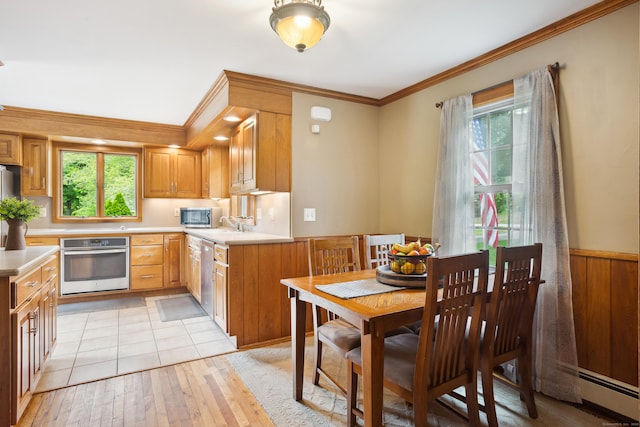 57 Falls Bashan Rd, East Haddam, CT 06469 - kitchen with stainless steel appliances, light countertops, light wood-type flooring, ornamental molding, and wainscoting