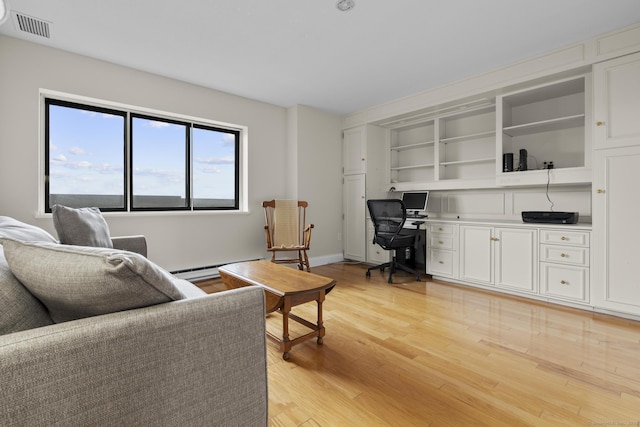 3200 Park Ave Unit 9B1, Bridgeport, CT 06604 - living area with light wood-style flooring, a baseboard heating unit, and an office area