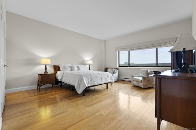 3200 Park Ave Unit 9B1, Bridgeport, CT 06604 - bedroom with a baseboard heating unit and light wood-style flooring